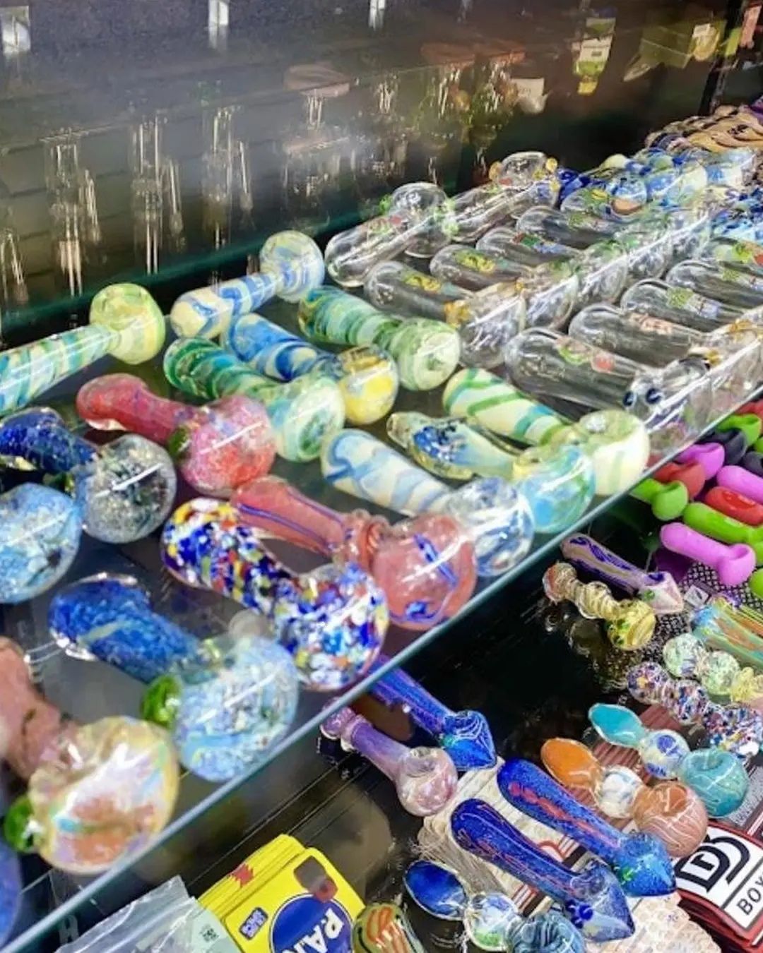 Colorful glass hand pipes in a retail counter display