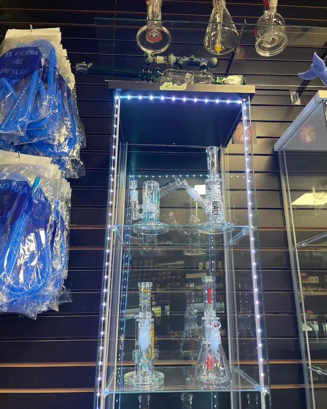 Glass rigs behind the lit glass cabinet door