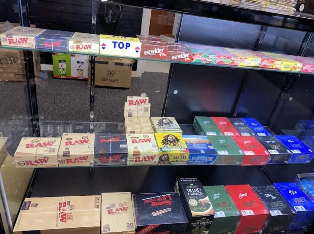 Rolling papers and boxed smoking accessories under glass