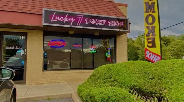 Exterior storefront with the former Lucky 7 Smoke Shop sign